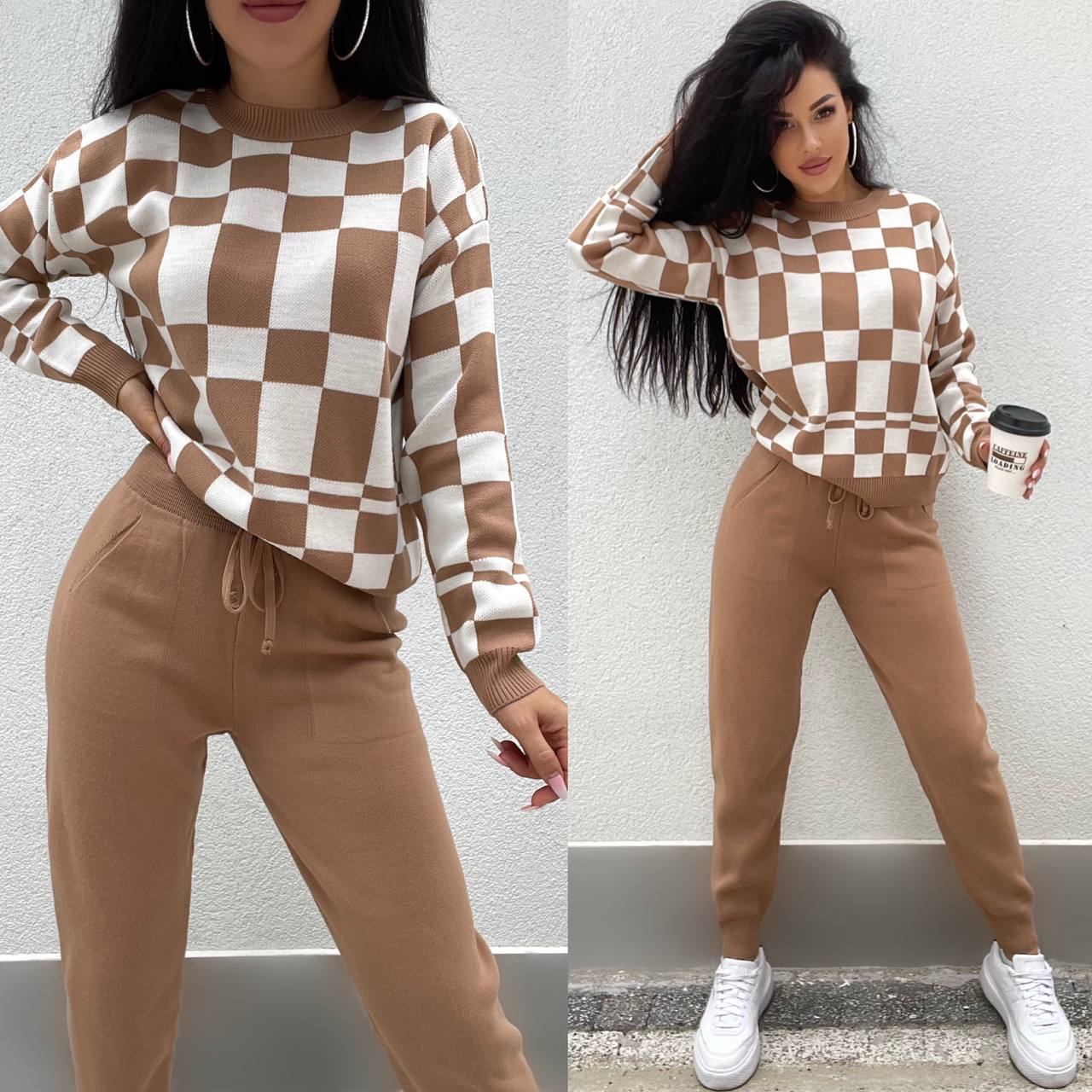 Woman wearing a checkered brown and white sweater and pants, holding a coffee cup.