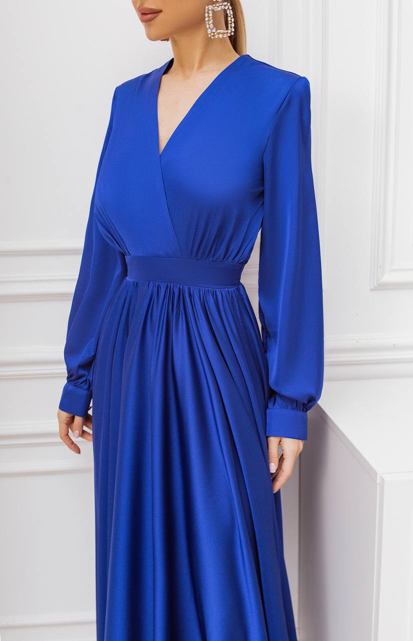 Blue evening gown with long sleeves on a white background