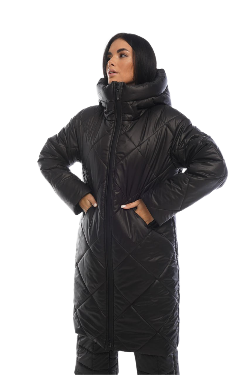 Person wearing a long black quilted coat on a white background