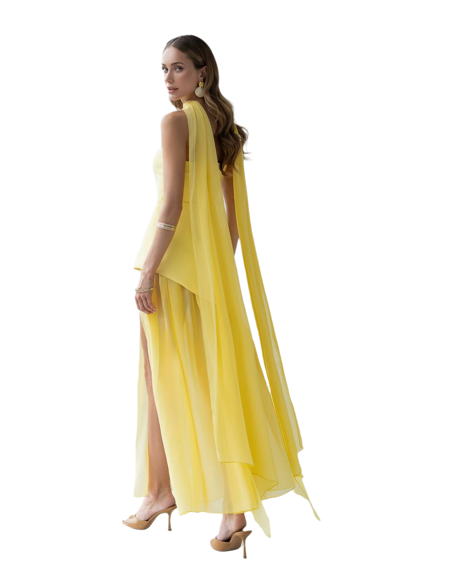 Woman wearing a yellow dress with a slit on a white background