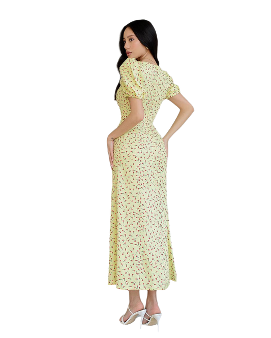 Woman wearing a yellow floral dress on a white background
