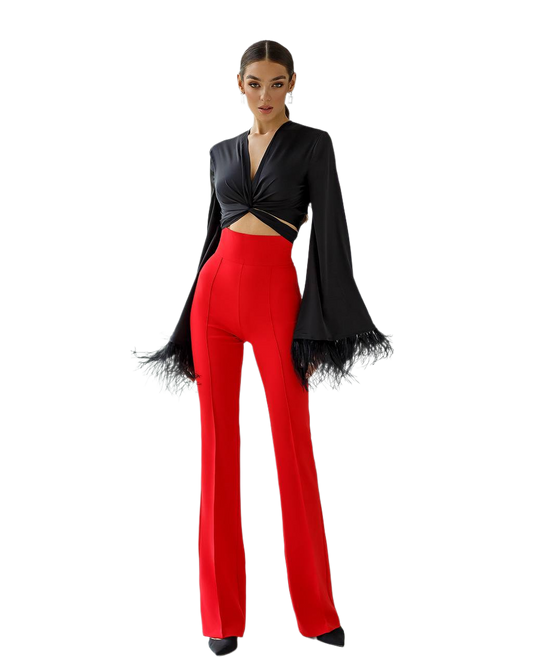 Woman wearing a black top and red pants on a white background