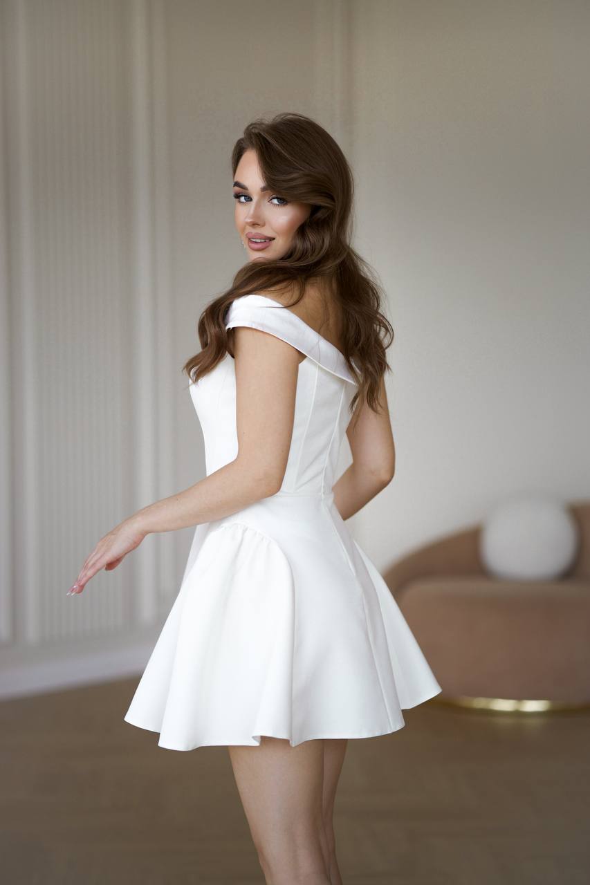 Woman wearing a white dress in an indoor setting
