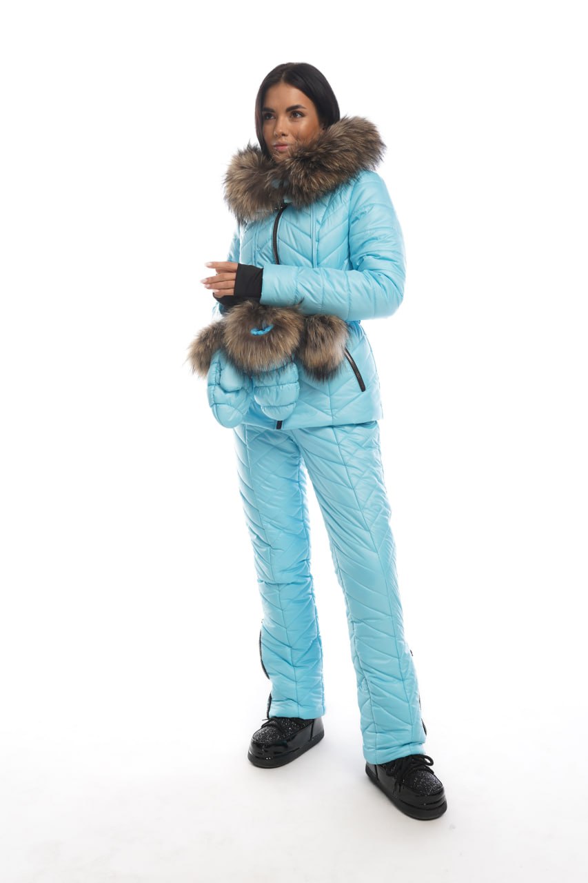 Person wearing a blue winter suit with fur-lined hood on a white background