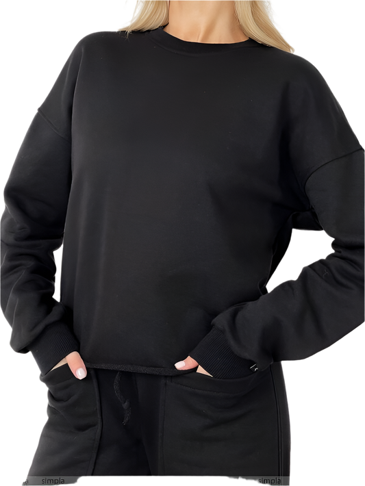 Person wearing a black sweatshirt and pants on a white background