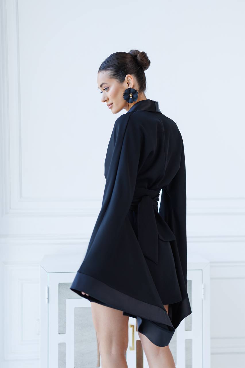 Woman wearing a black dress with a white background