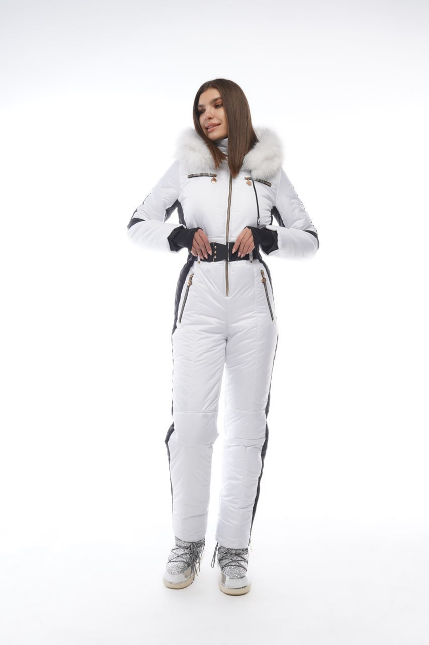 Person wearing a white ski suit with black accents on a white background