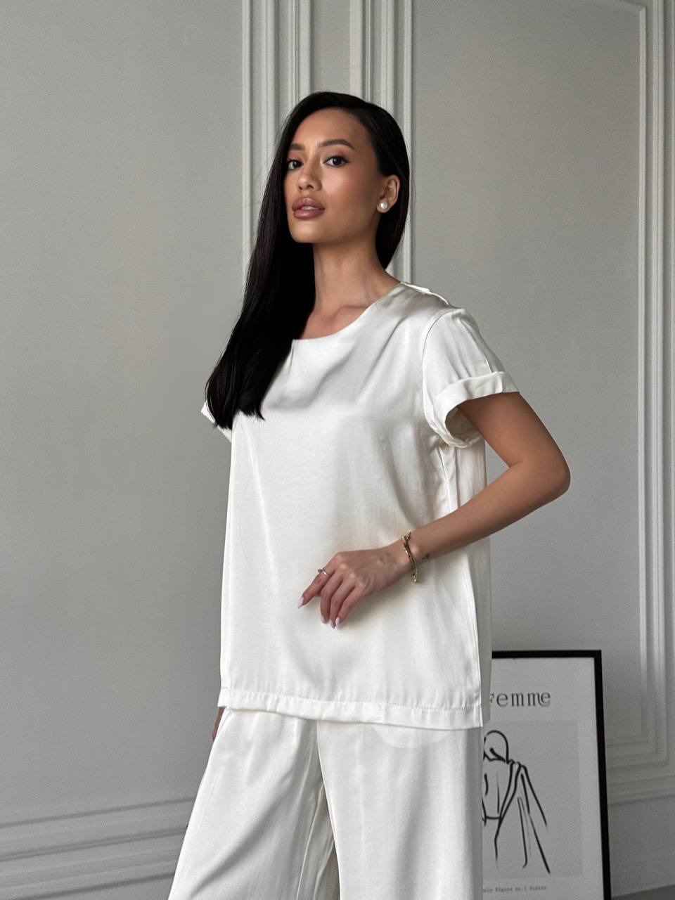 Woman wearing a white outfit in a minimalistic setting