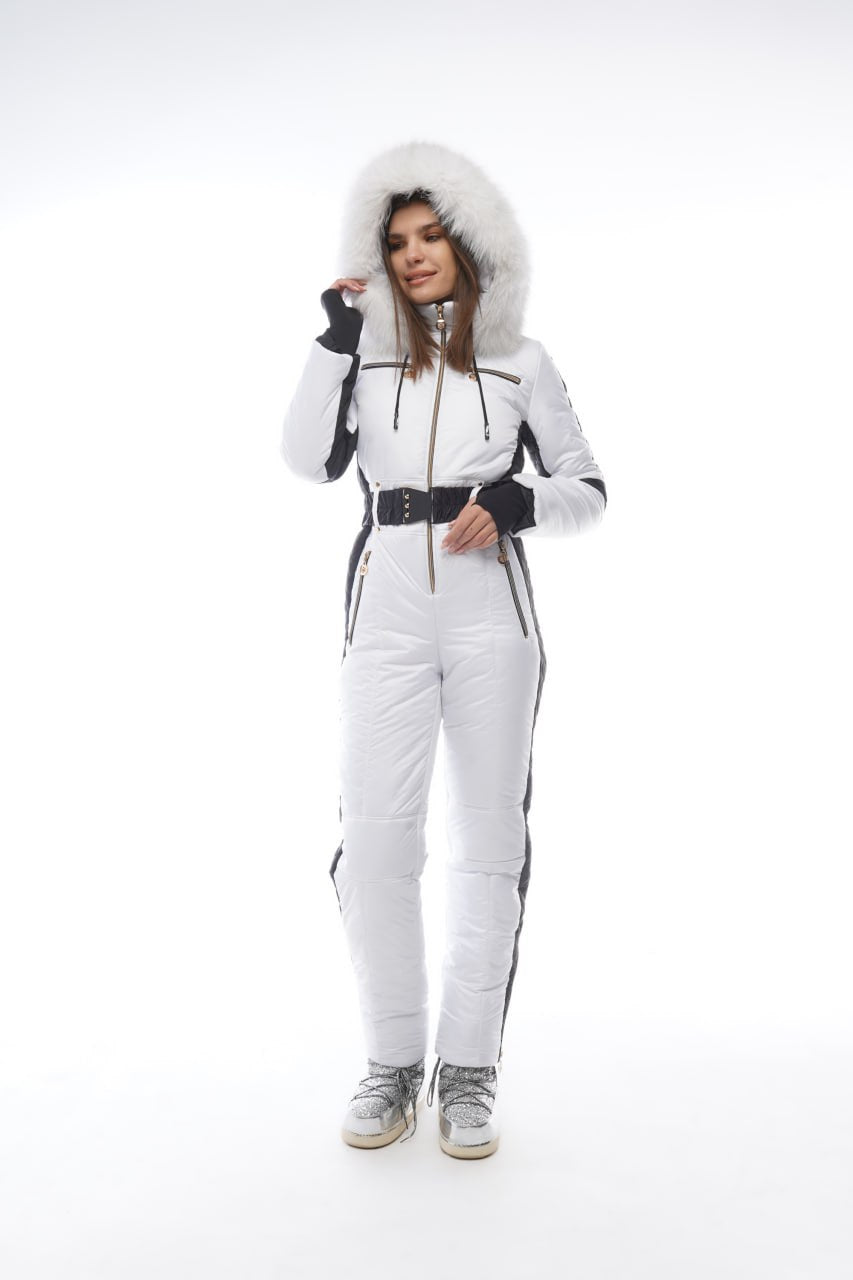 Person wearing a white snowsuit with black accents on a white background