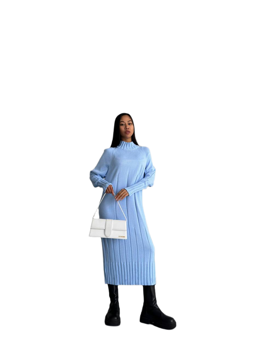 Woman wearing a light blue ribbed dress holding a white handbag on a white background
