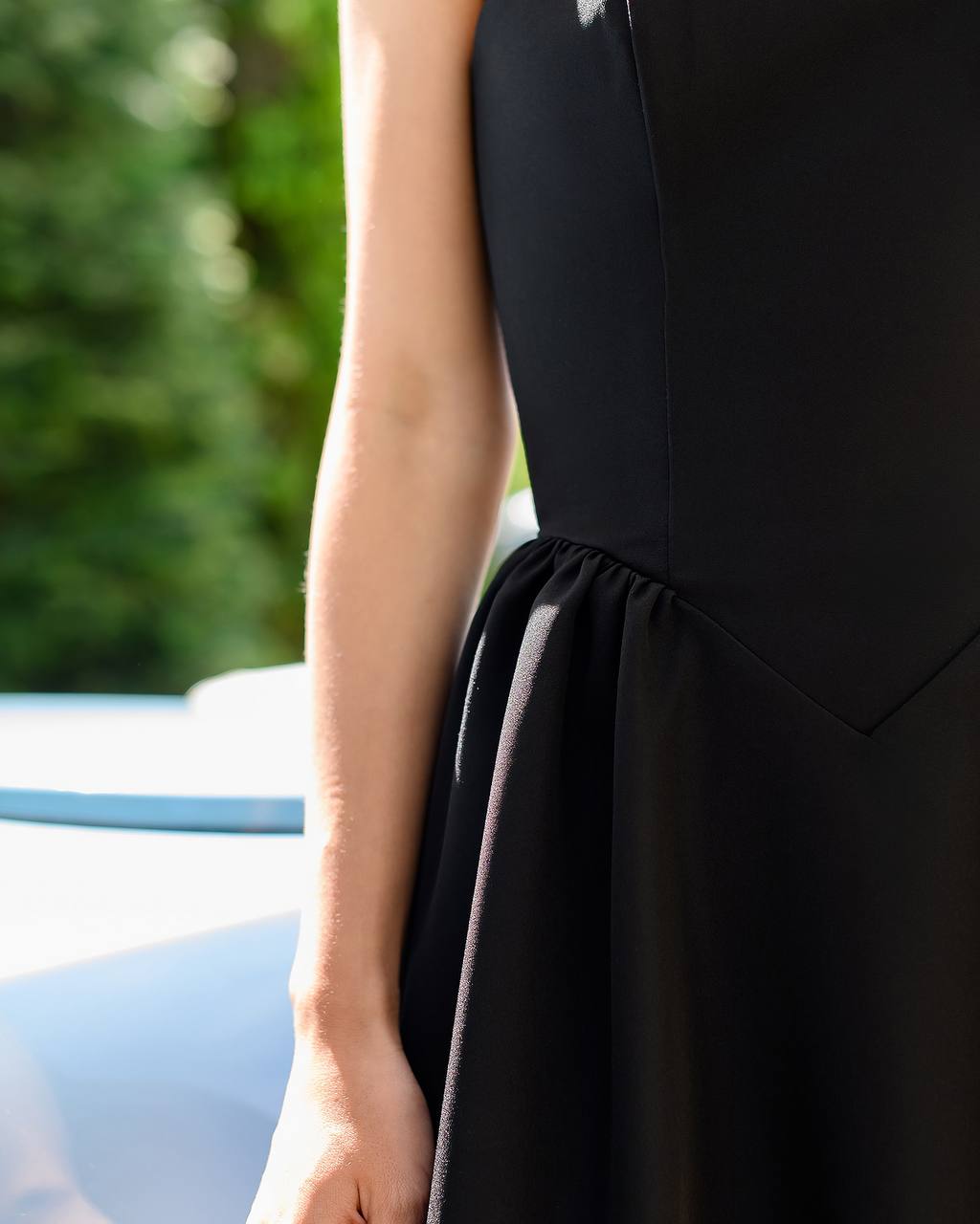Black dress with a blurred green background