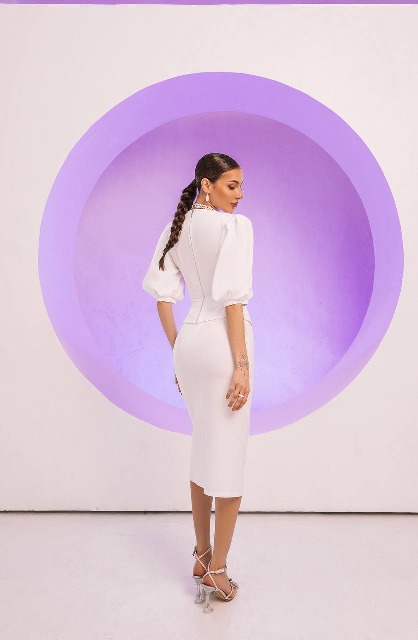 Woman in a white dress standing against a purple circular background