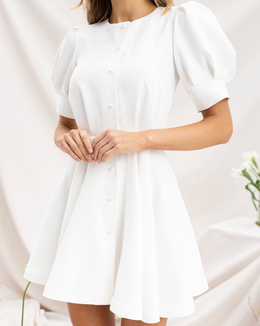 White dress with puff sleeves on a white background