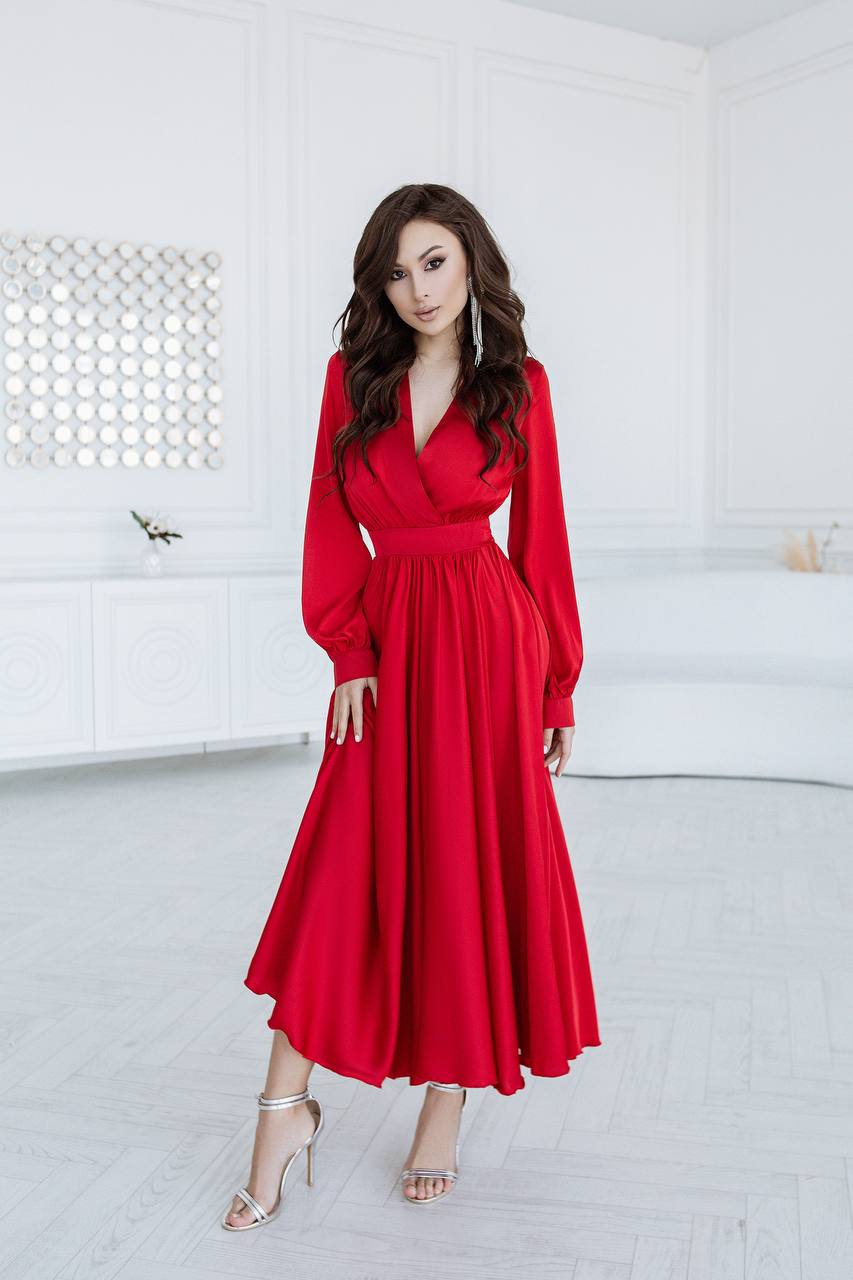Woman wearing a red dress in a white room