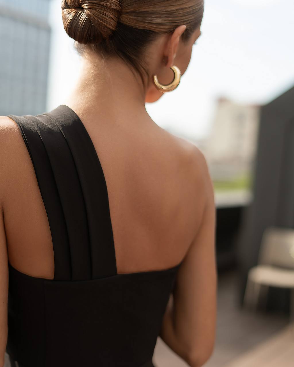 Woman wearing a black dress with a blurred background