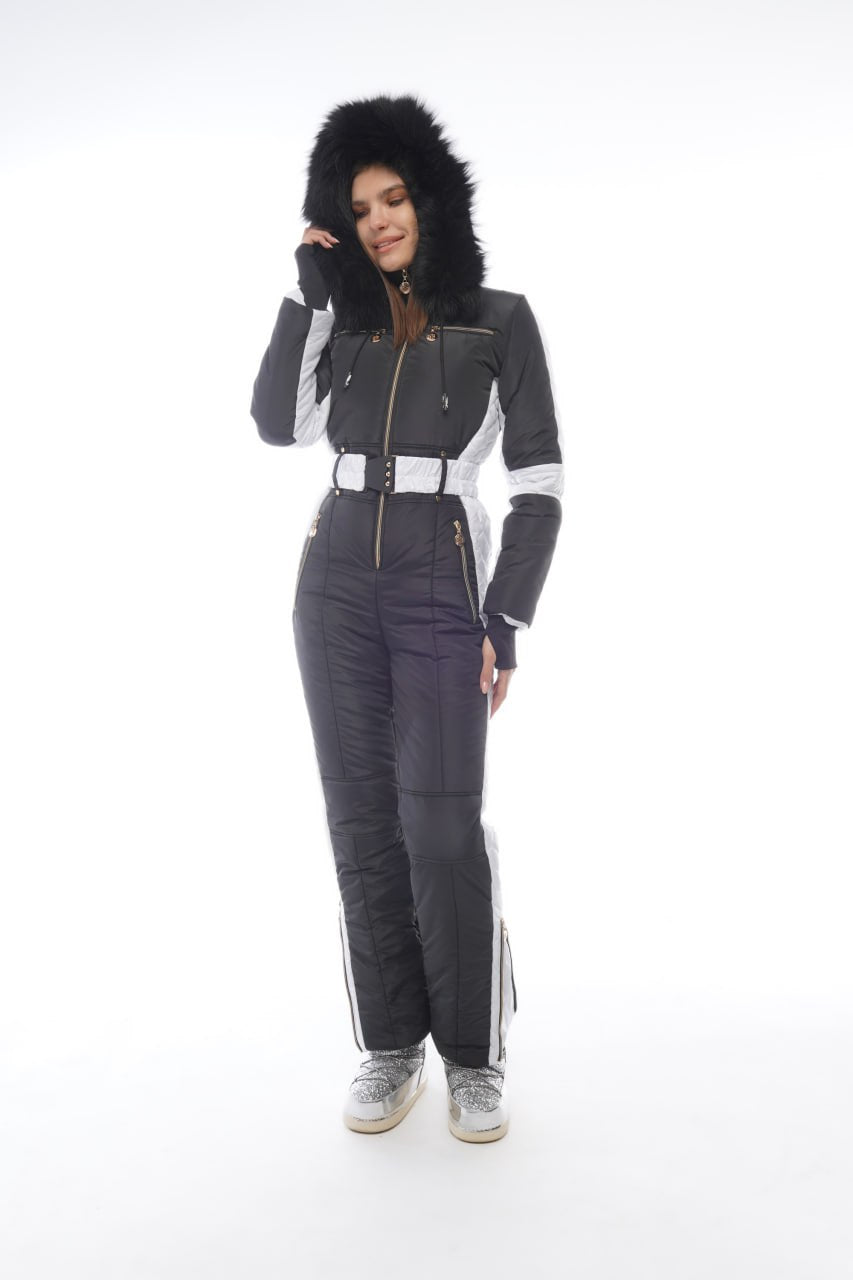 Person wearing a gray and white snowsuit with a hood on a white background