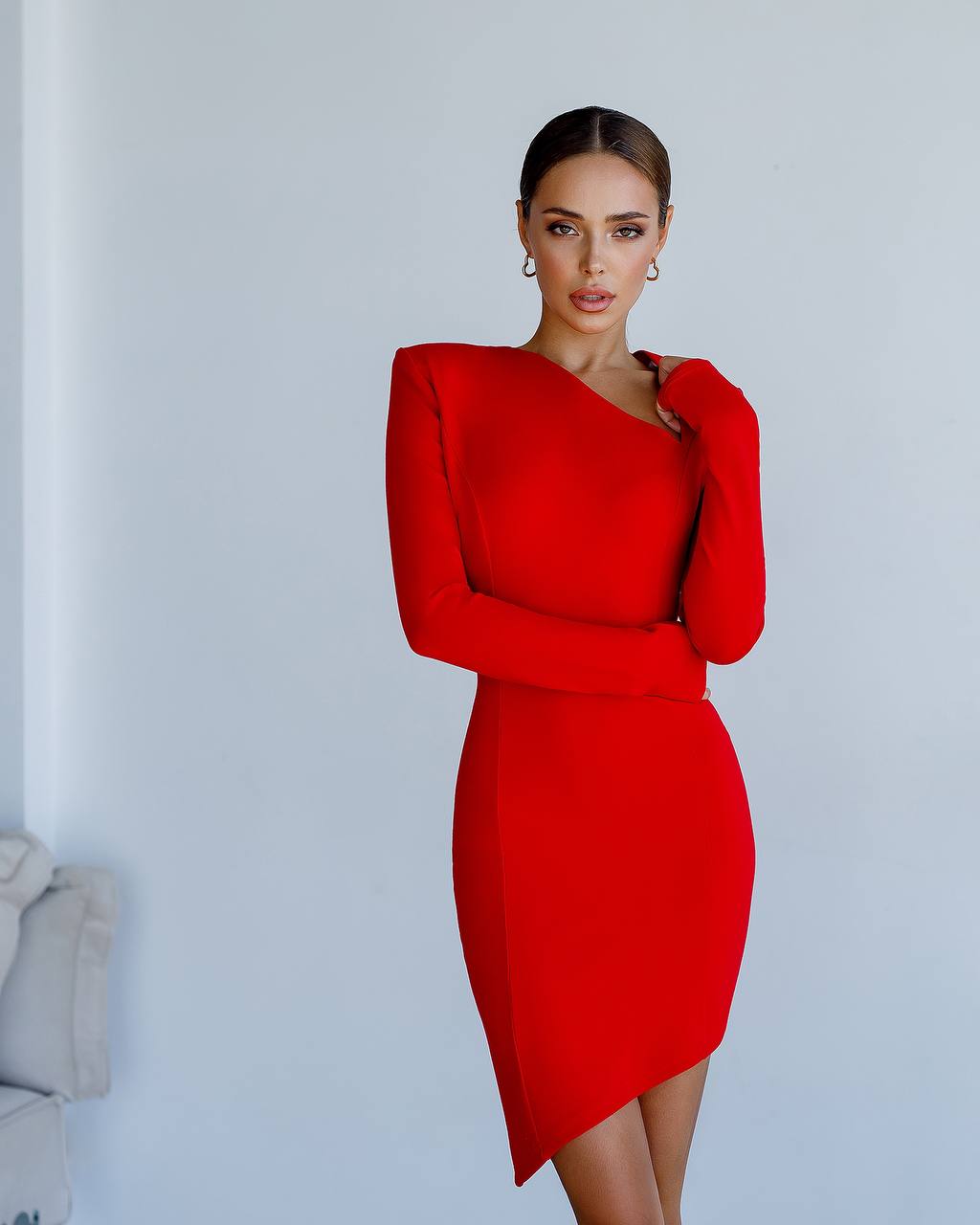Woman wearing a red dress against a light gray background