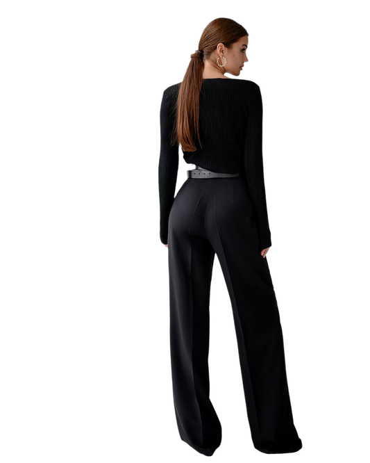 Woman wearing a black jumpsuit on a white background