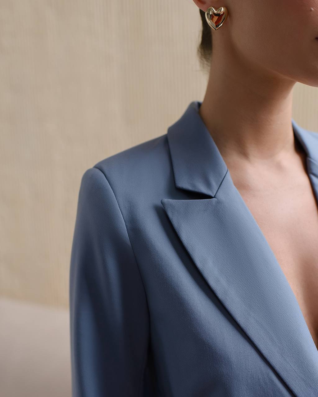 Blue blazer worn by a person with a neutral background