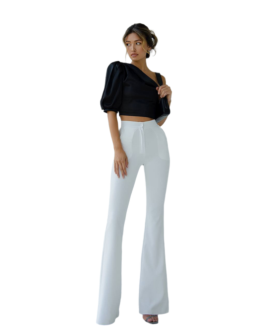 Woman wearing a black top and white pants on a white background