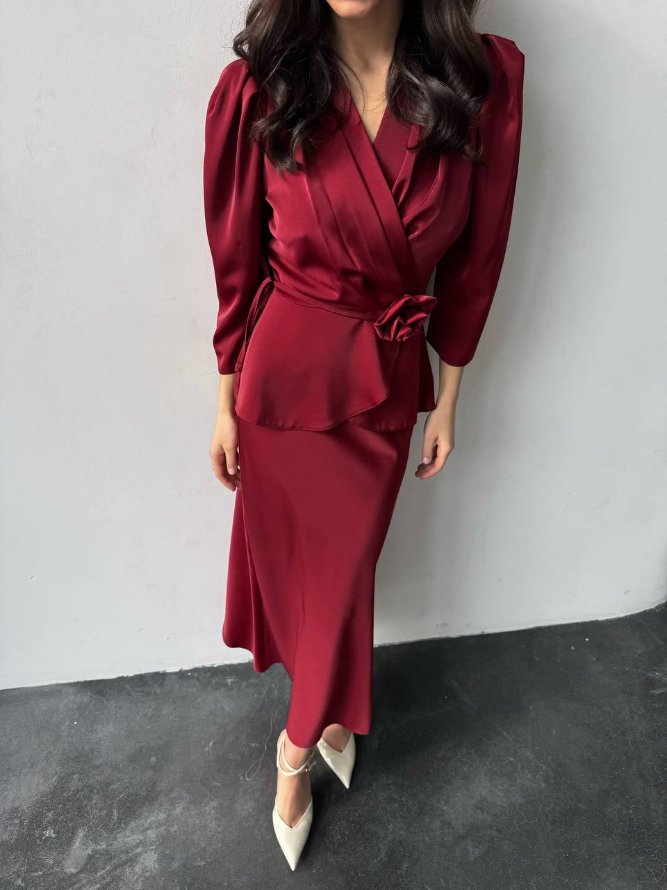 Person wearing a burgundy outfit with a white background