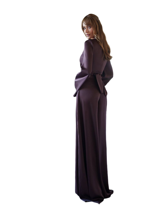 Woman wearing a long dark purple dress on a white background