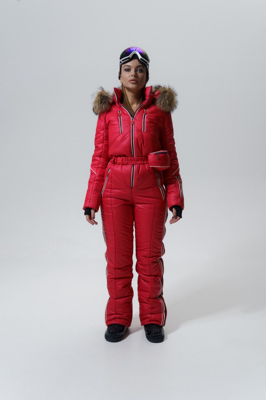 Person wearing a red snowsuit with fur hood on a white background