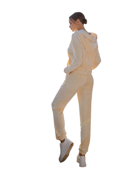 Person wearing a beige tracksuit on a white background