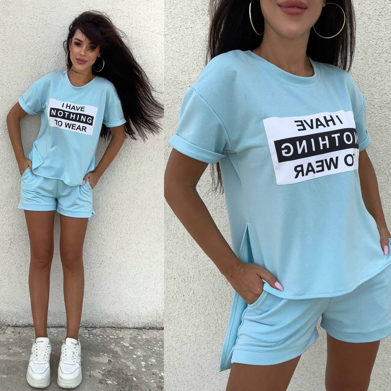 Woman wearing a light blue outfit with a t-shirt and shorts, standing against a plain background.