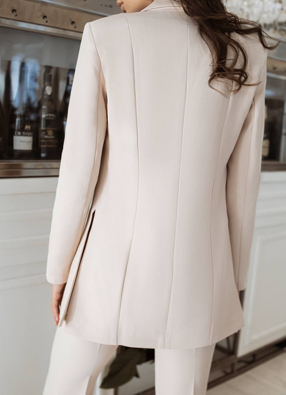 Person wearing a light pink coat in an indoor setting