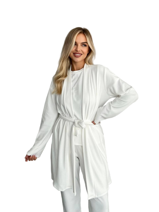 Woman wearing a white outfit with a belt on a white background