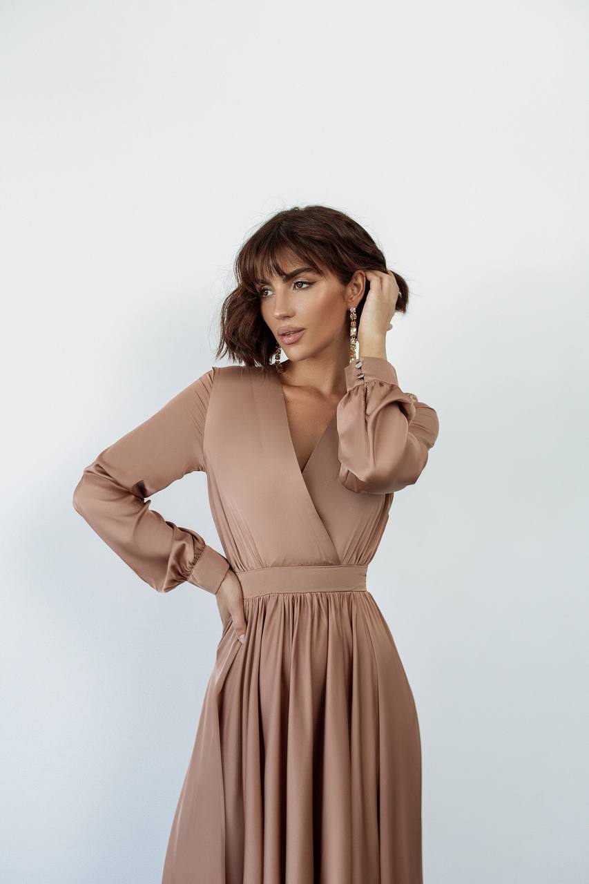Woman wearing a brown dress against a light background