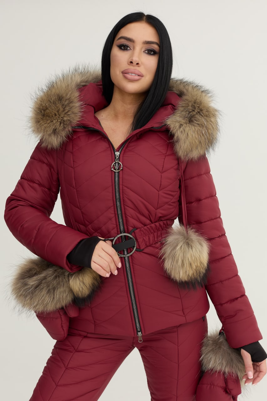 Red puffer jacket with fur trim worn by a model on a white background
