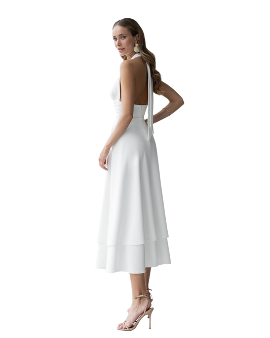 Woman wearing a white dress with a backless design on a white background
