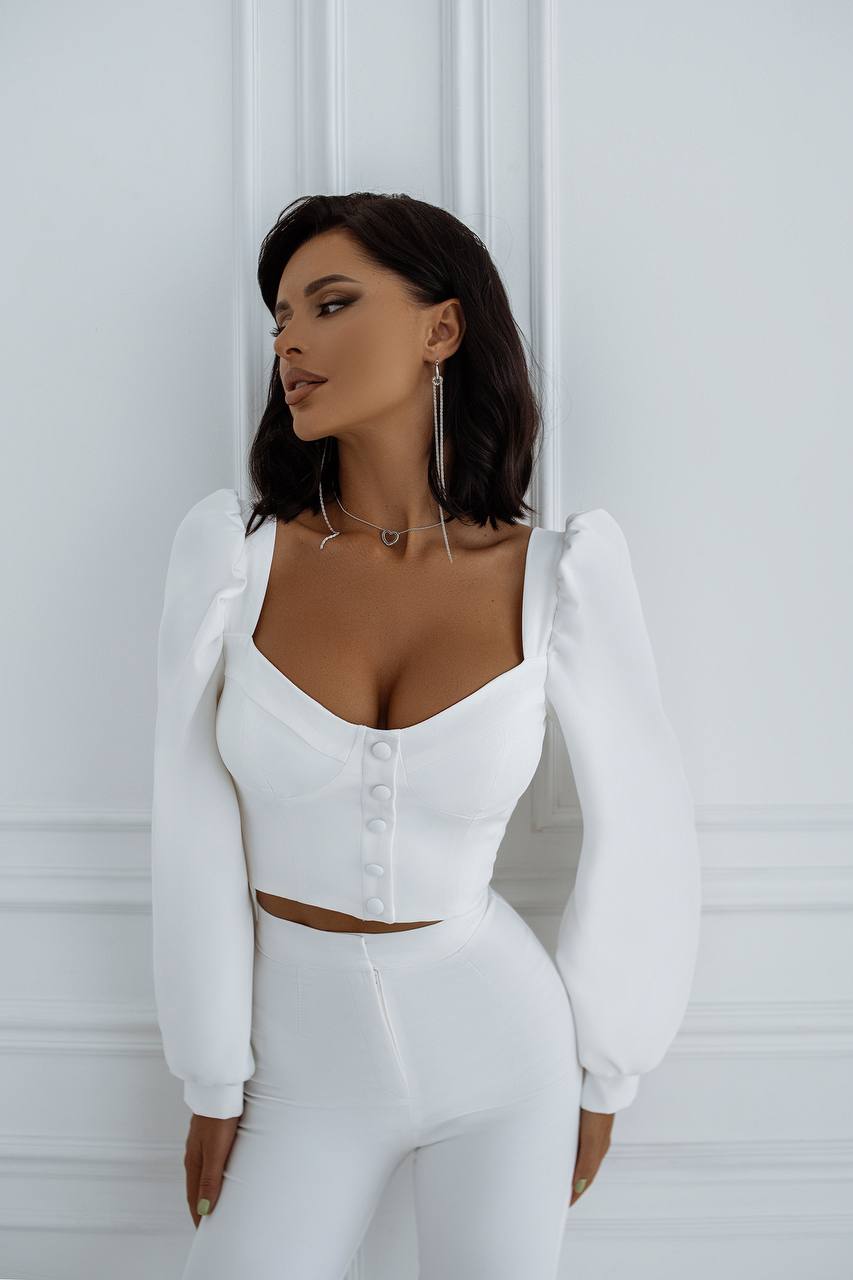 Woman wearing a white outfit against a white background