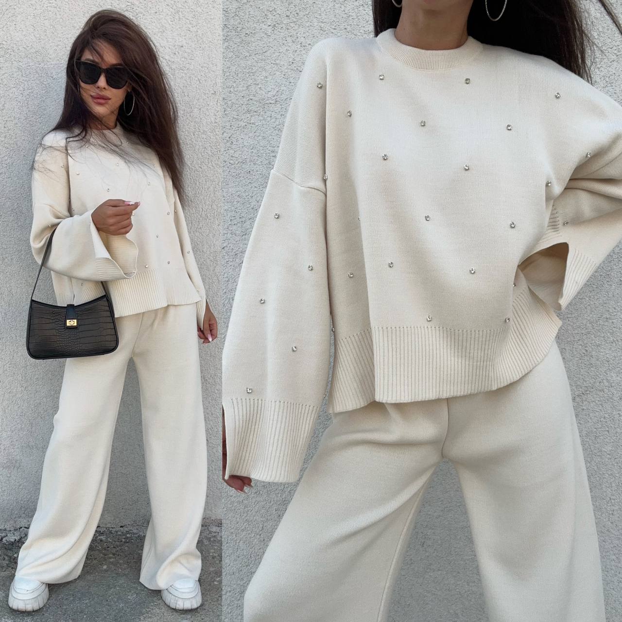Woman wearing a cream-colored outfit with embellishments against a gray wall.