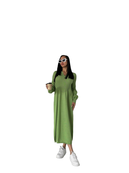 Woman wearing a green dress and white sneakers on a white background
