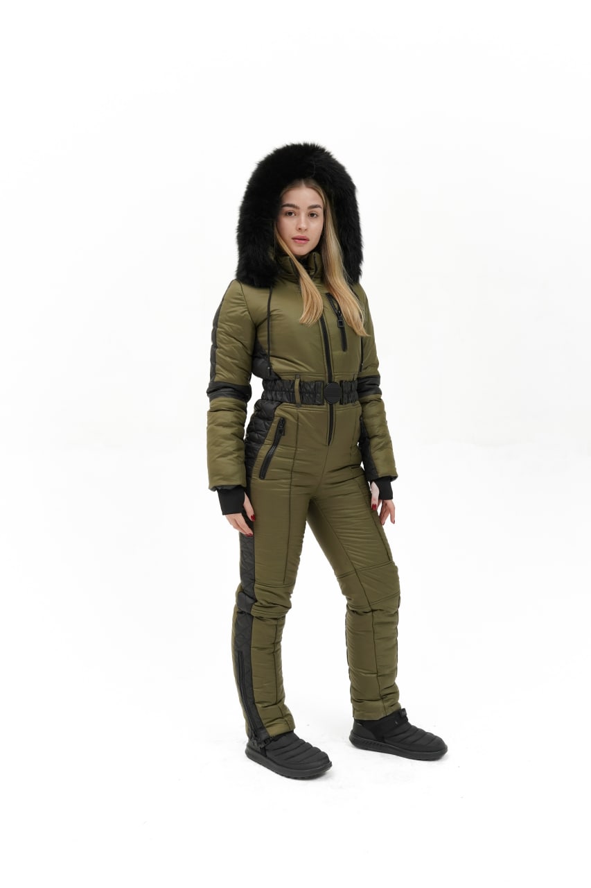 Person wearing a green and black futuristic suit with a fur-lined hood on a white background