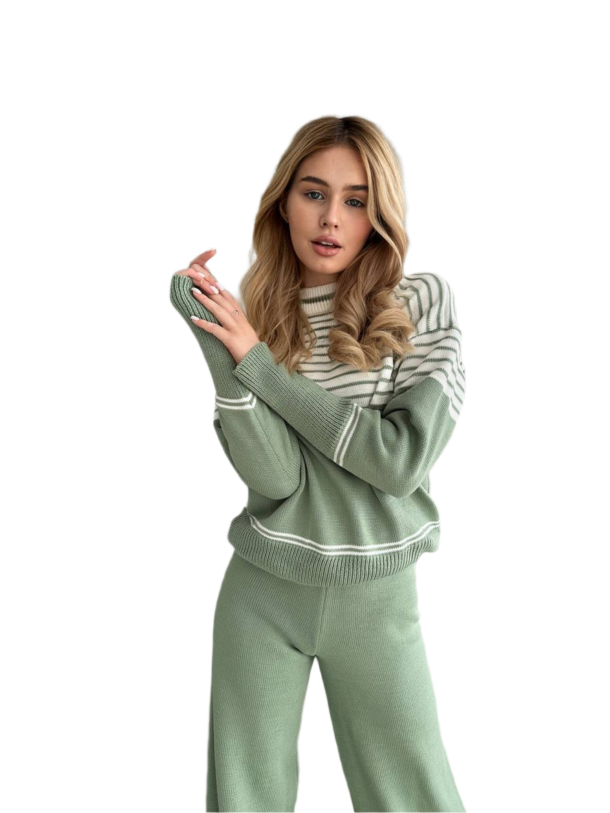 Woman wearing a green and white striped sweater and pants on a white background