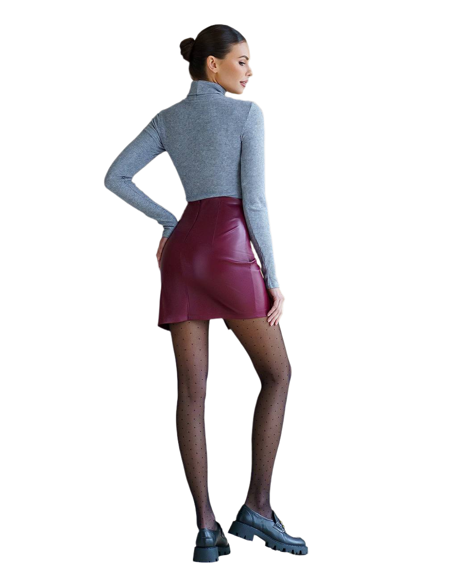Woman wearing a gray turtleneck and maroon leather skirt on a white background