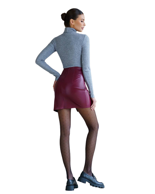 Woman wearing a gray turtleneck and maroon leather skirt on a white background