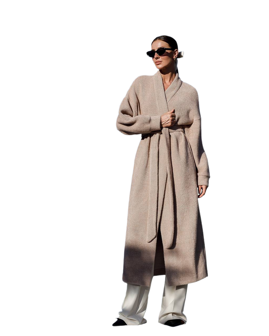 Person wearing a long beige coat on a white background