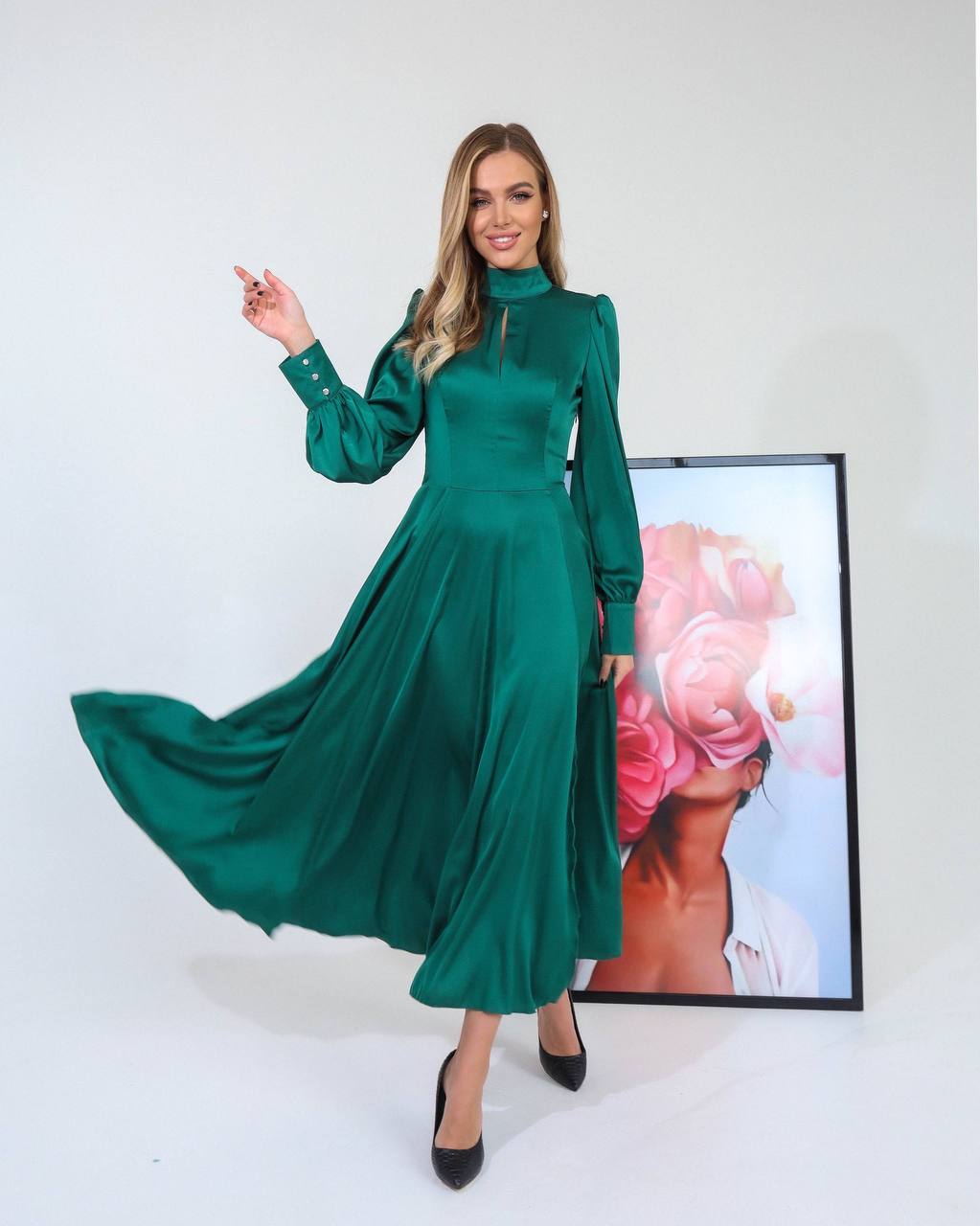 Woman wearing a green dress with a white background