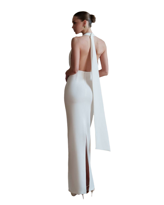White evening gown with a high slit and open back on a white background