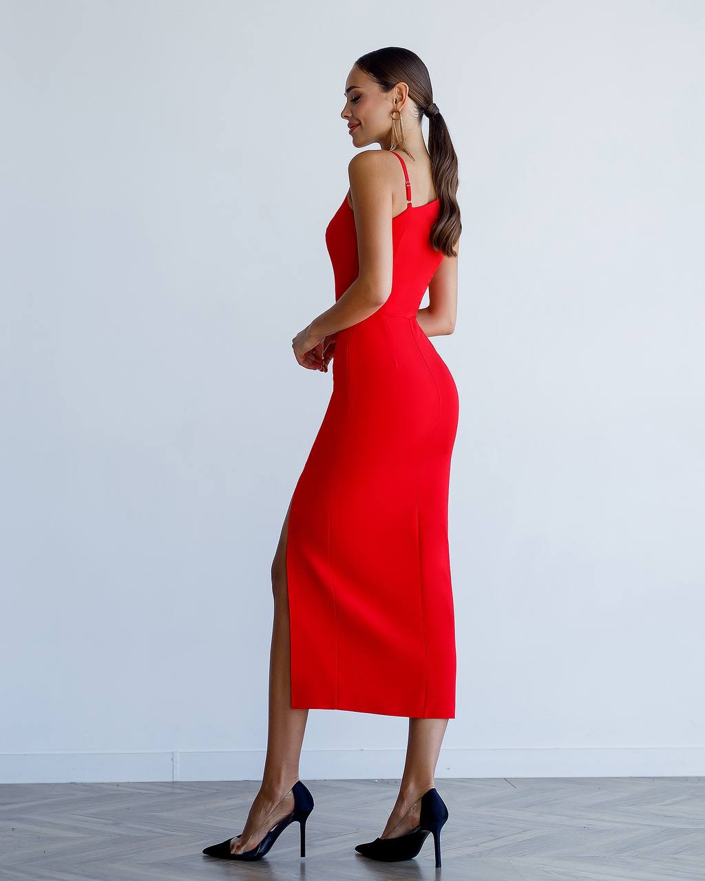 Woman wearing a red dress with a white background