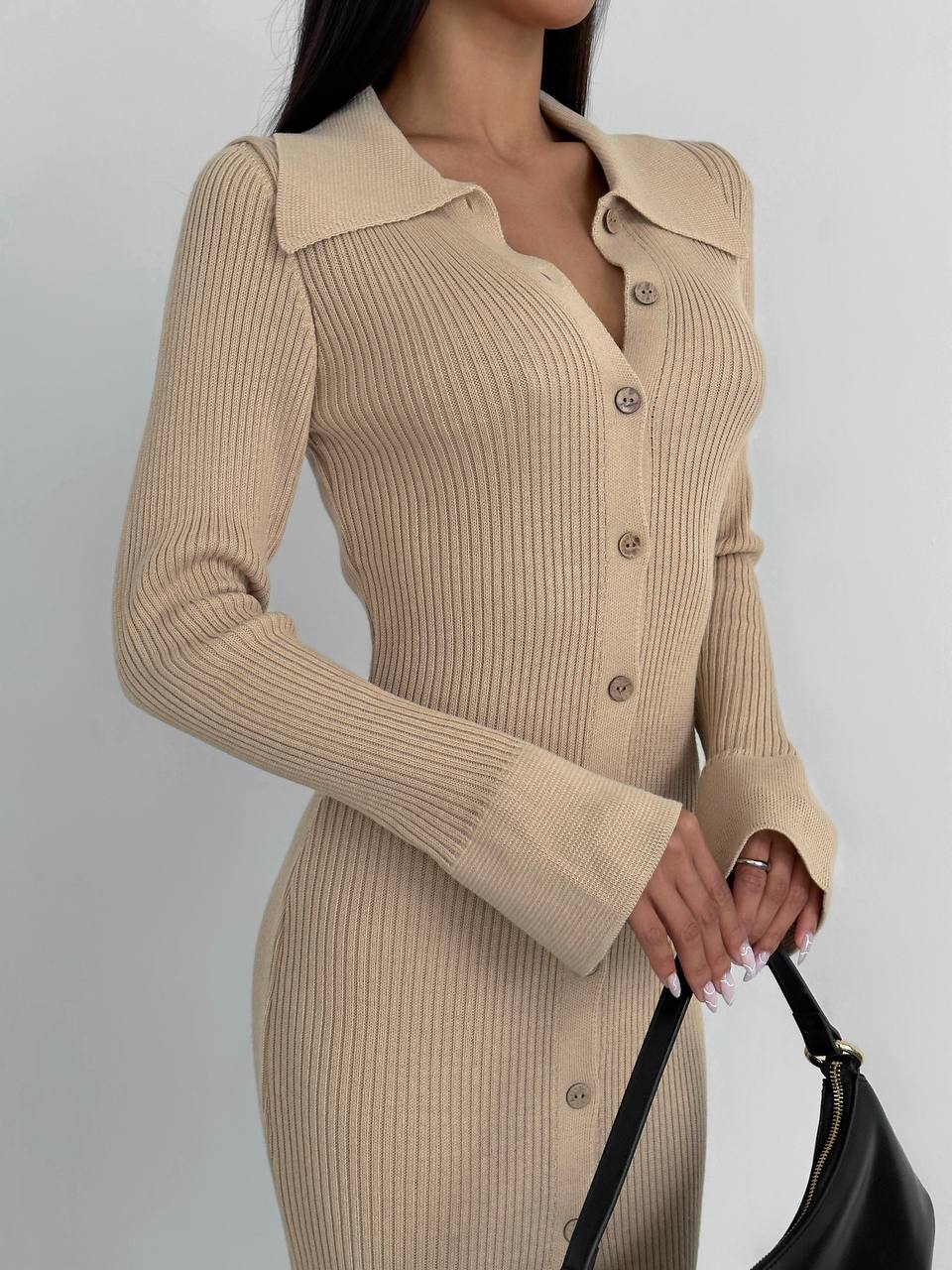 Beige ribbed dress worn by a person on a plain background