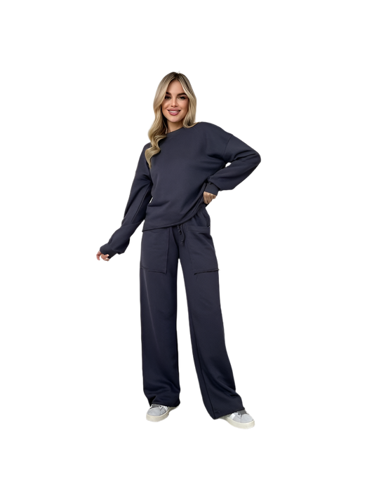 Woman wearing a navy blue tracksuit on a white background
