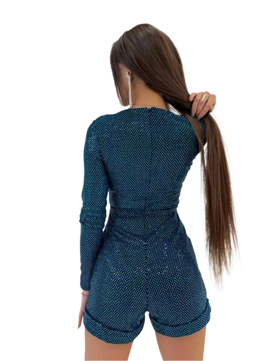 Woman wearing a teal long-sleeve top and shorts set on a white background