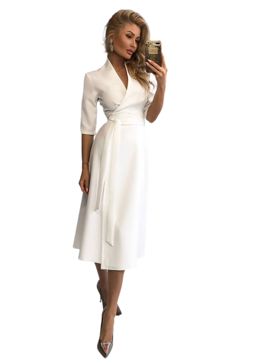 Woman in a white dress taking a selfie on a white background