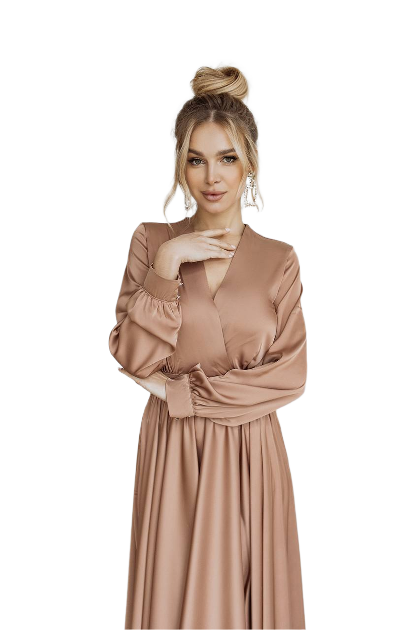 Woman wearing a long, light brown dress on a white background